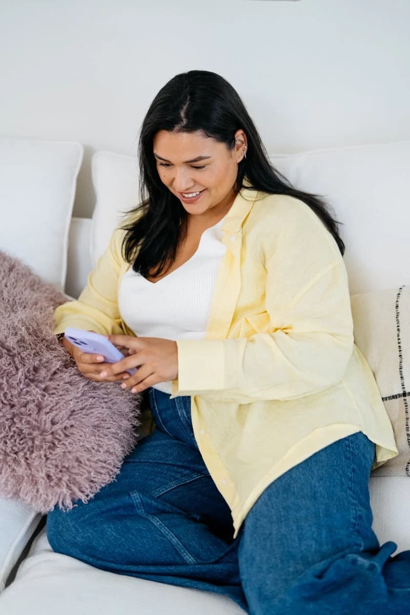 Member messaging her provider from the couch